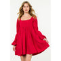 Woman wearing a red dress with long sleeves on a white background
