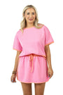 Woman wearing a pink outfit with a white background