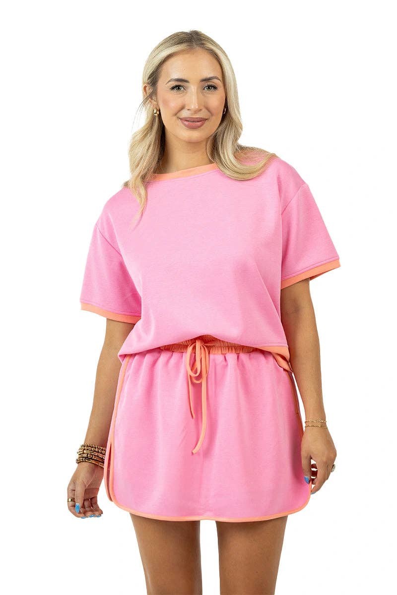 Woman wearing a pink outfit with a white background