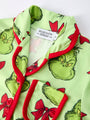 Children's pajama set with Grinch design on a white background