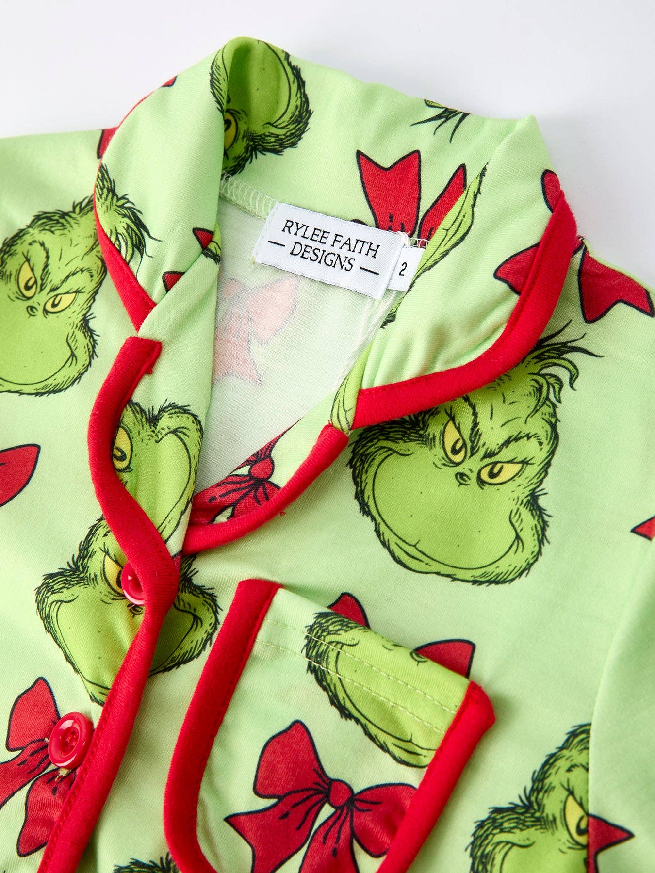 Children's pajama set with Grinch design on a white background