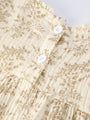 Close-up of a floral-patterned fabric with white buttons on a light background