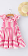 Pink and white striped dress on a hanger with a straw hat on a light gray background