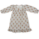 A long-sleeve night gown with a beige and white geometric pattern, featuring a ruffled hem and elasticized cuffs.
