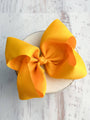 Large yellow bow on a white background