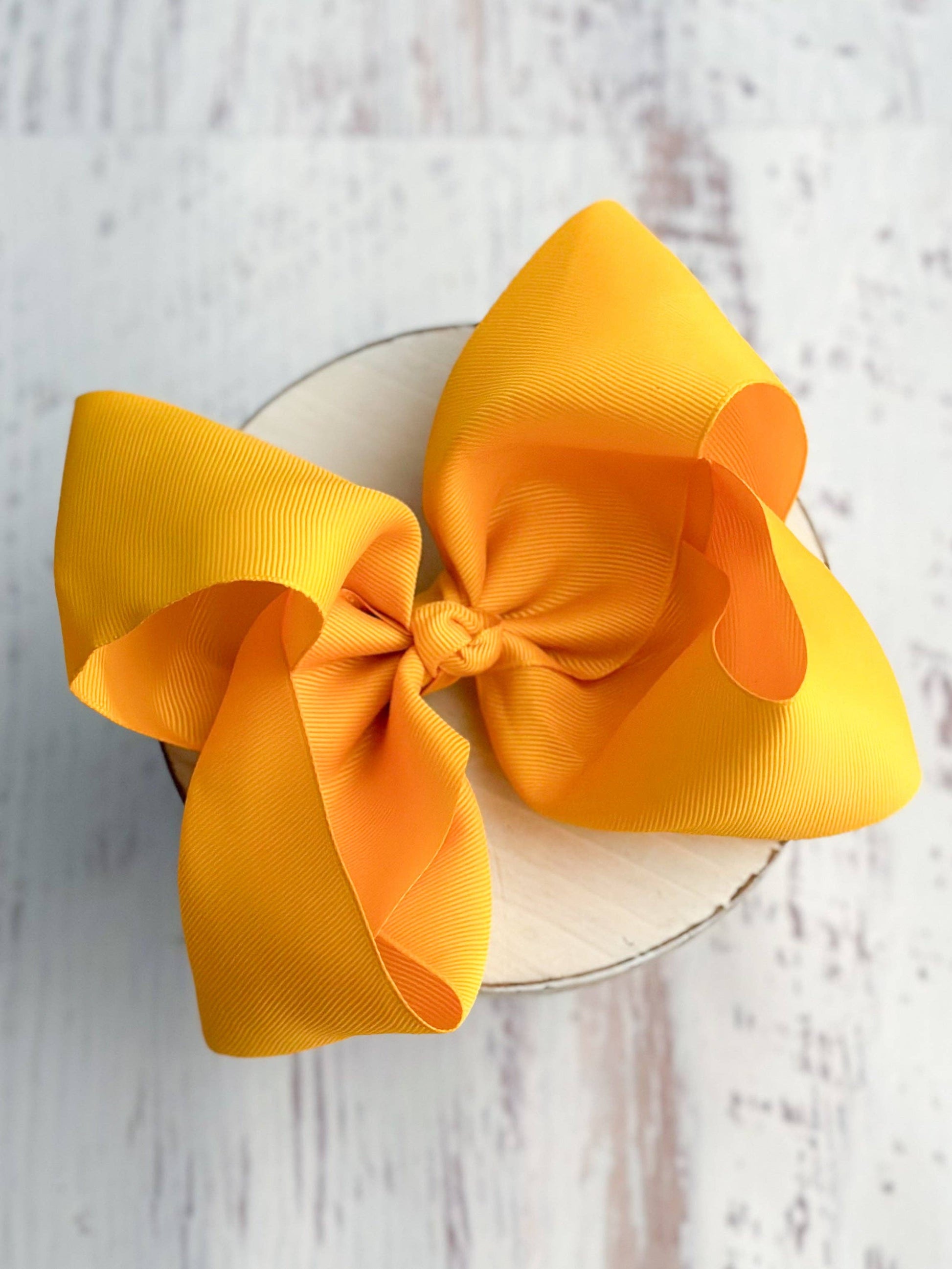 Large yellow bow on a white background