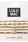 Set of gold and black beaded bracelets on LULU MAC packaging