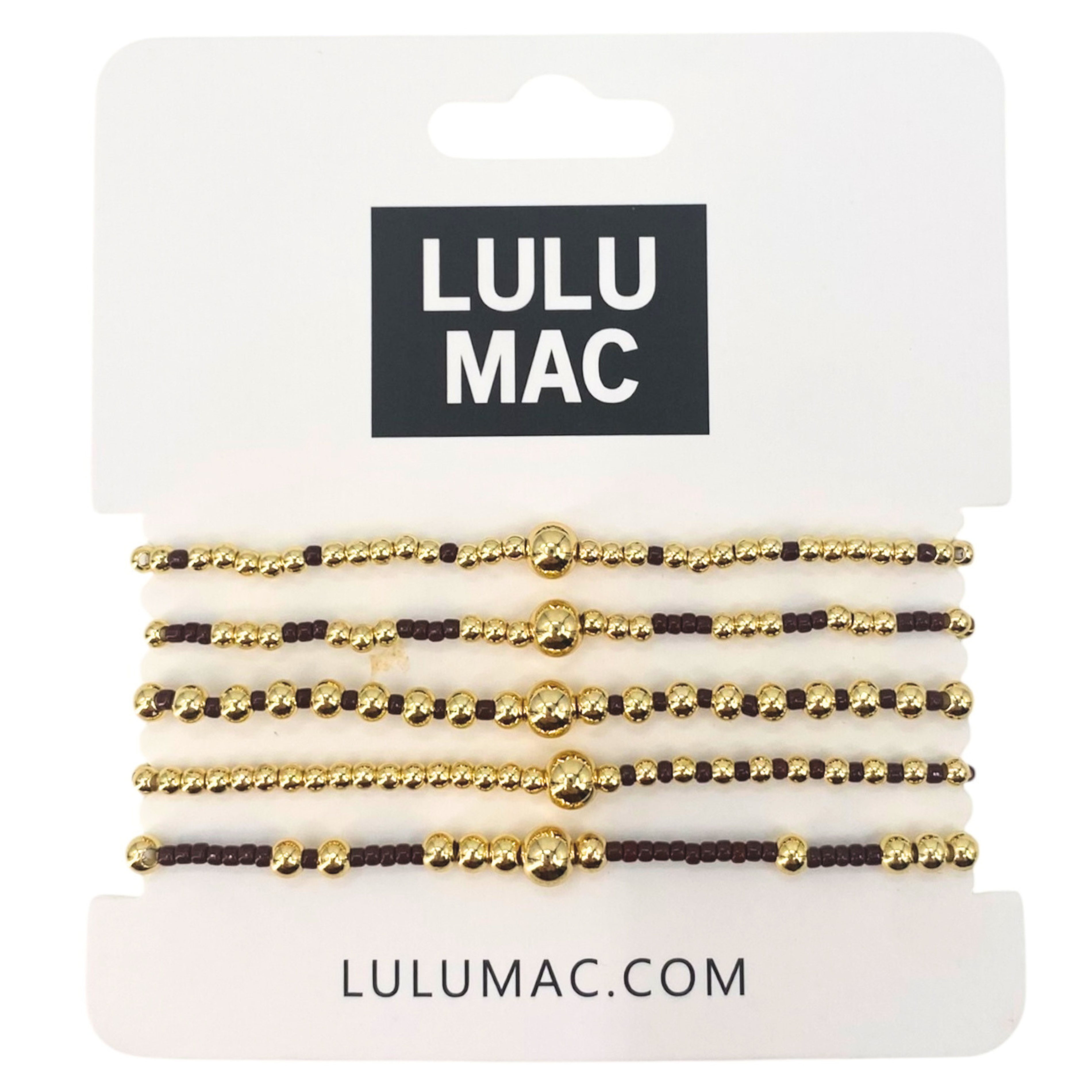 Set of gold and black beaded bracelets on LULU MAC packaging