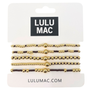 Set of gold and black beaded bracelets on LULU MAC packaging
