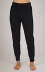 Black jogger pants worn by a person on a plain background