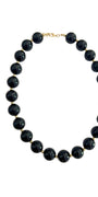 Chunky beaded necklace with dark round black beads and gold-tone clasp