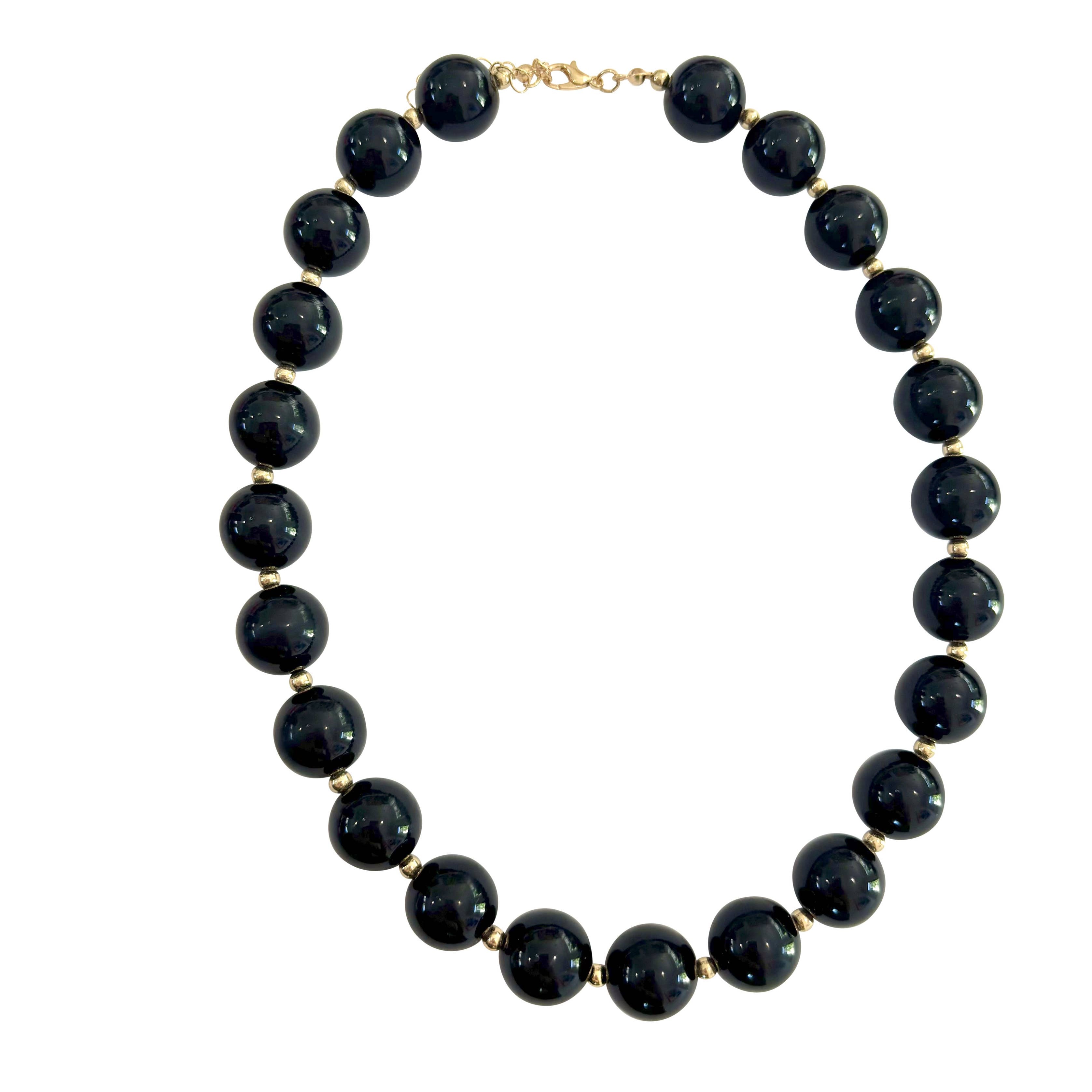 Chunky beaded necklace with dark round black beads and gold-tone clasp
