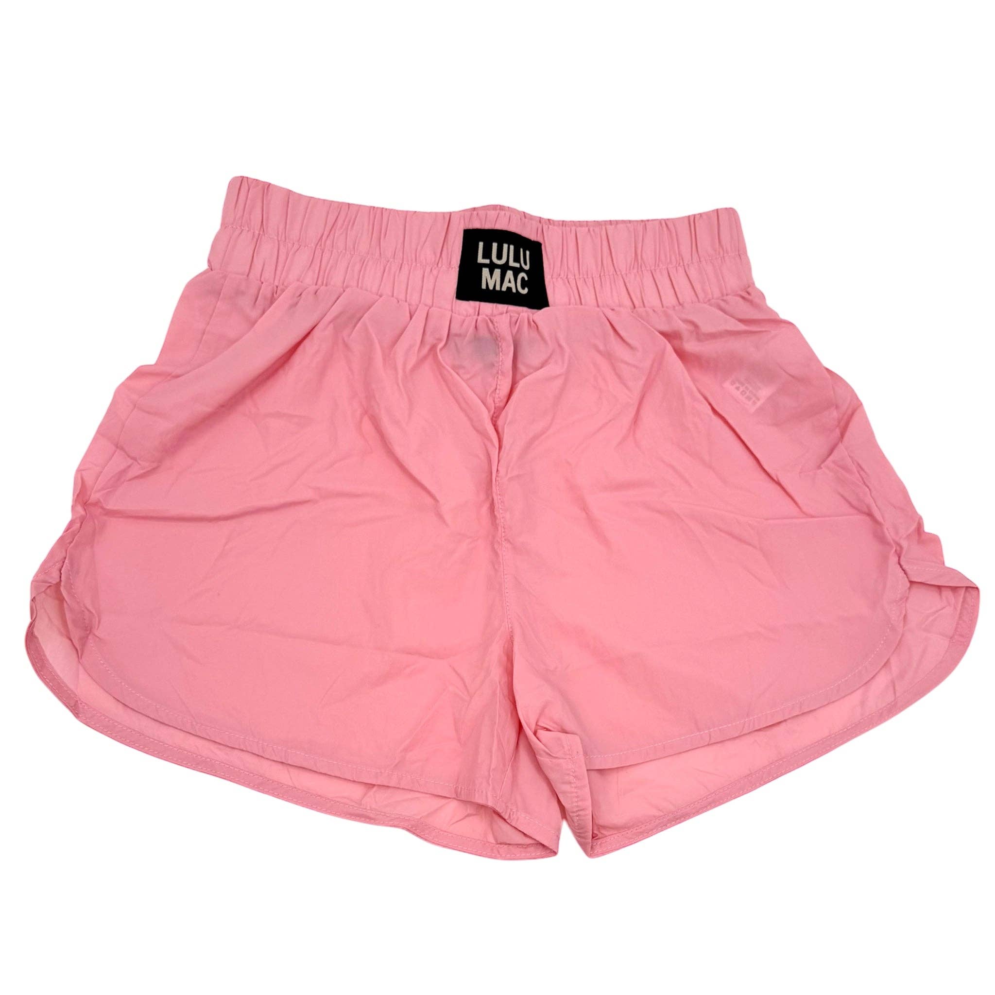 Pink shorts with a visible brand label on a white background