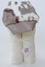 Plush toy with cow print top and beige bottom on a white background