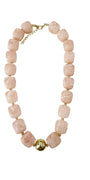 Chunky taupe beaded necklace with gold chain and round charm at center