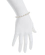 Pearl bracelet on a white hand with a white background
