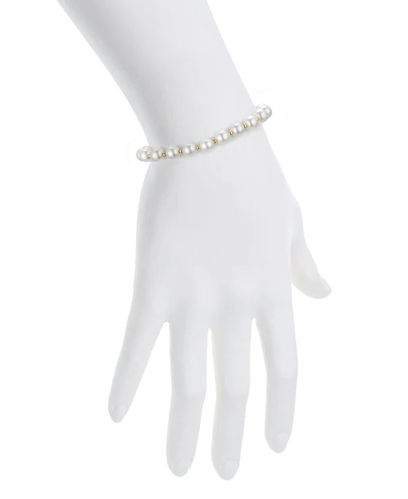 Pearl bracelet on a white hand with a white background