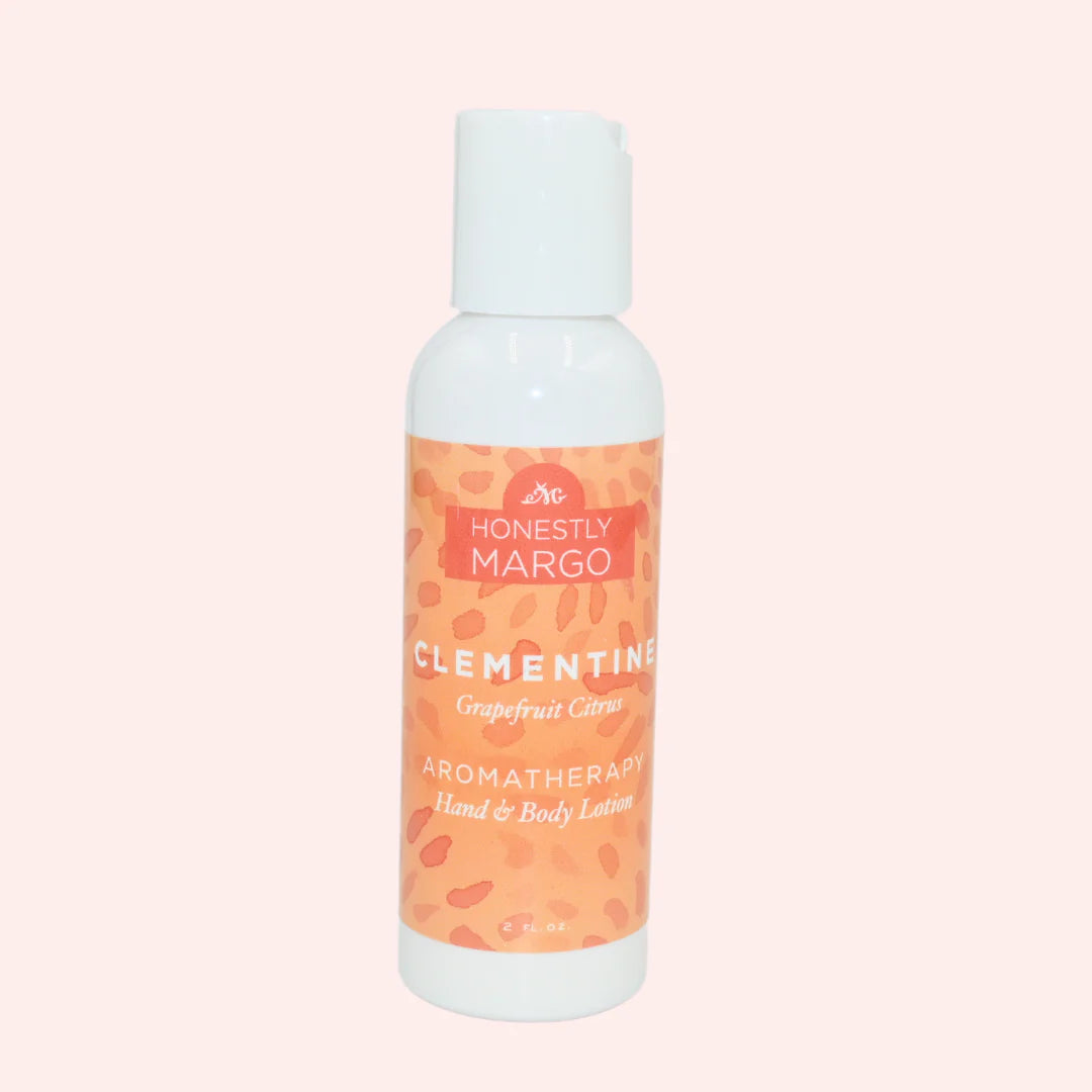 Honestly Margo Clementine Grapefruit Citrus aromatherapy hand and body lotion bottle on a light pink background