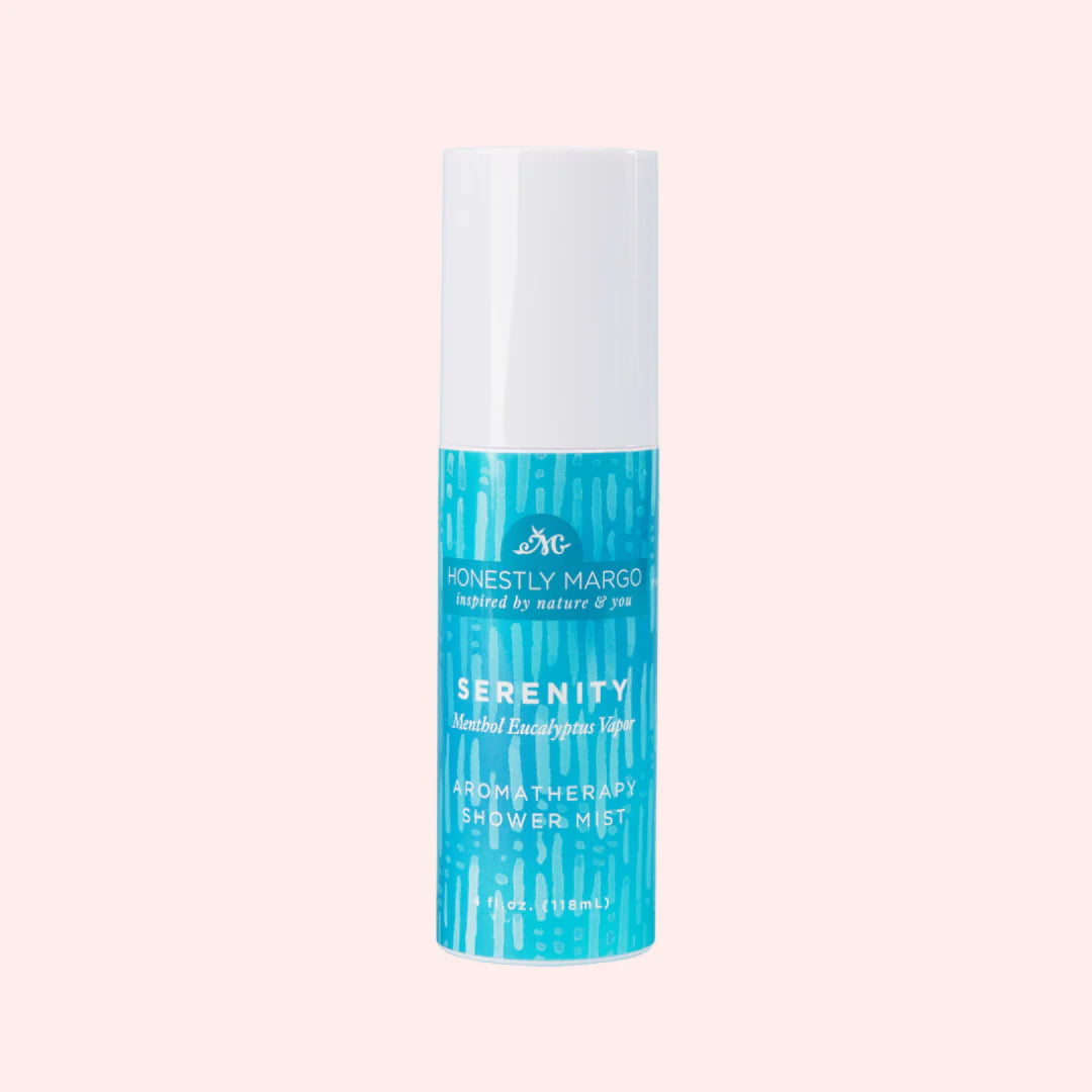 Shower mist bottle with blue and white design on a light pink background