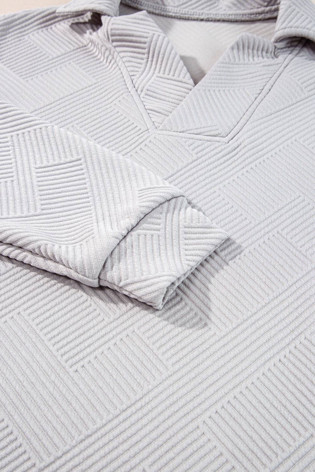 Close-up of textured gray fabric with a geometric pattern
