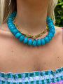 Chunky beaded necklace with teal oval beads and gold link clasp