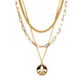 Three gold necklaces with a pendant on a white background