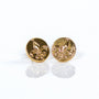 Pair of gold fleur-de-lis earrings on a white background