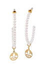 Pearl necklace with gold pendants on a white background