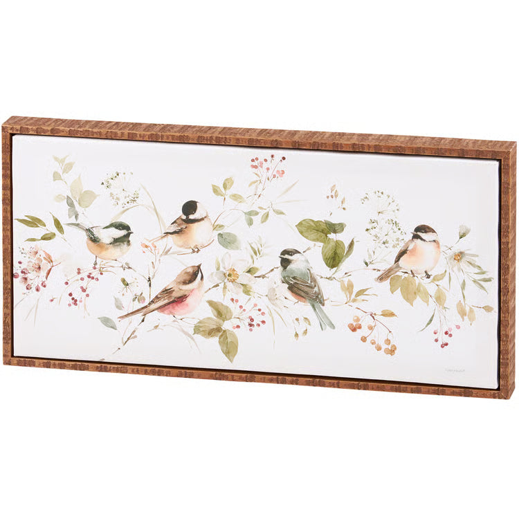 Decorative wall art with birds and floral elements in a wooden frame.
