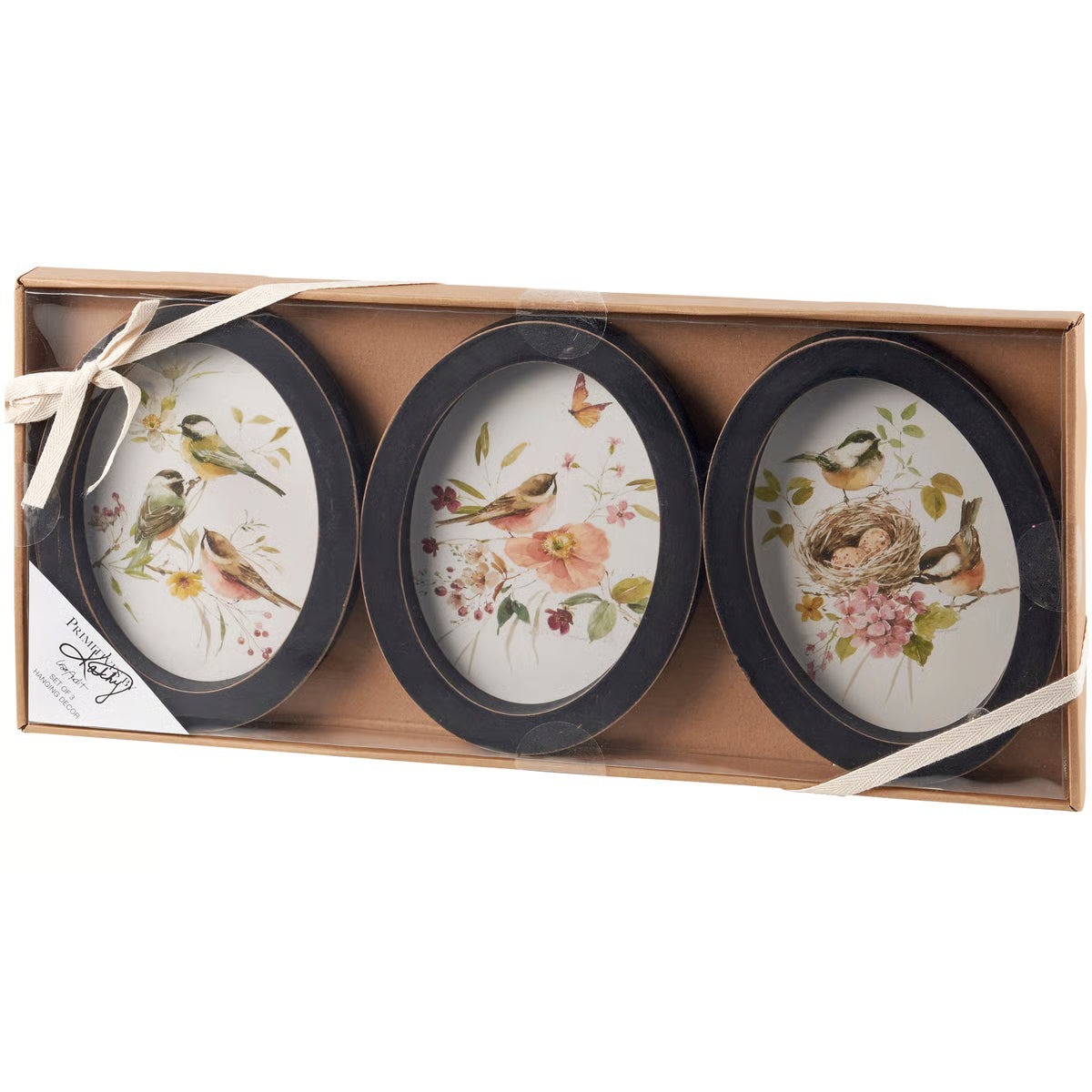 Three decorative plates with bird and floral designs in a cardboard box.