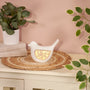 Decorative white bird-shaped lamp with gold内心 on a table with plants and books in the background.
