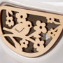 Wooden decorative panel with floral patterns on a white background