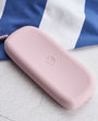 Lilac silicone eyeglass case with Peepers logo on a white and blue striped background