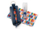 Blue keychain pouch, colorful striped pouch, and white bottle on a white background