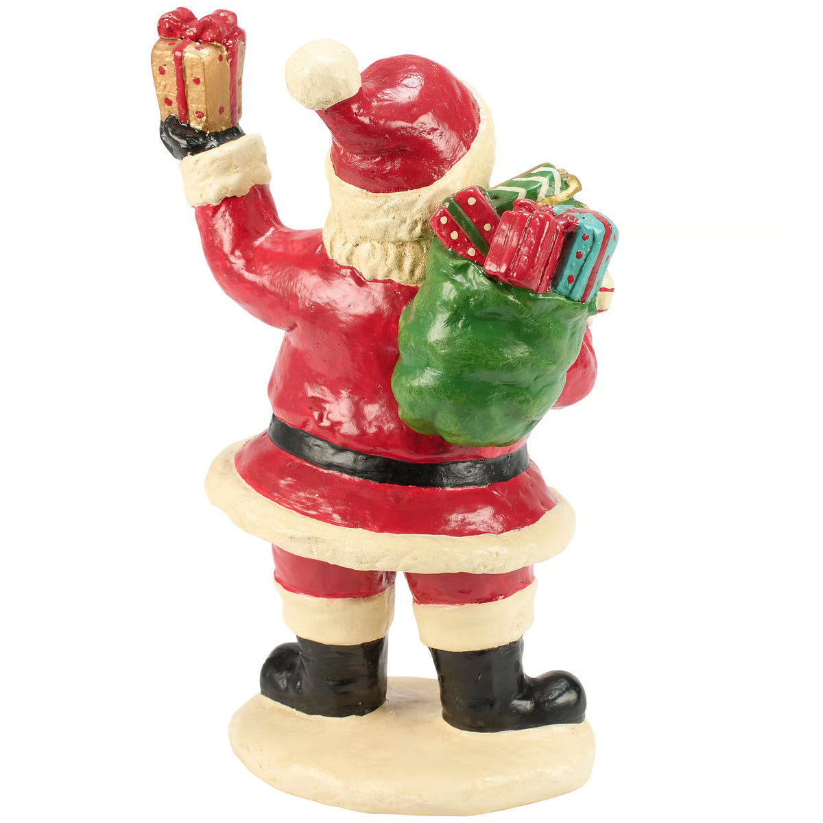 A Santa Claus figurine holding a wrapped gift in one hand and a green sack of presents in the other, shown against a plain white background.