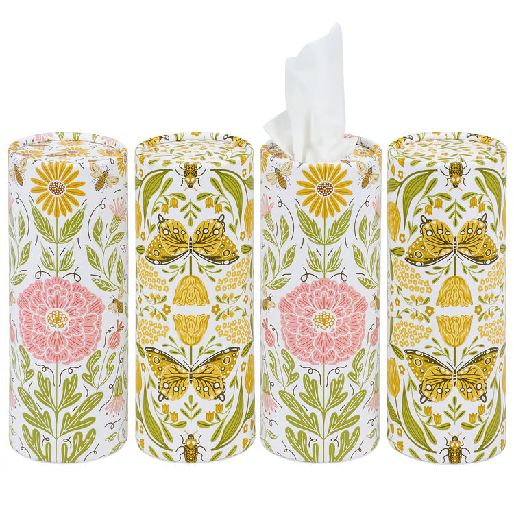 Four cylindrical tissue paper rolls with floral and butterfly designs on a white background