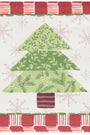 A square quilted napkin featuring a Christmas tree applique design. The tree is constructed from three layered green patterned triangles with pine branches and small white berries, set against a white background with light pink snowflakes.