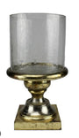 Decorative candle holder with clear glass and gold base on a white background