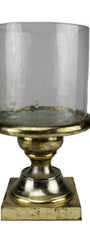 Decorative candle holder with clear glass and gold base on a white background