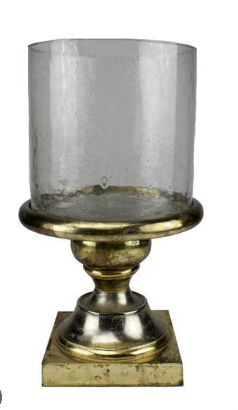 Decorative candle holder with clear glass and gold base on a white background