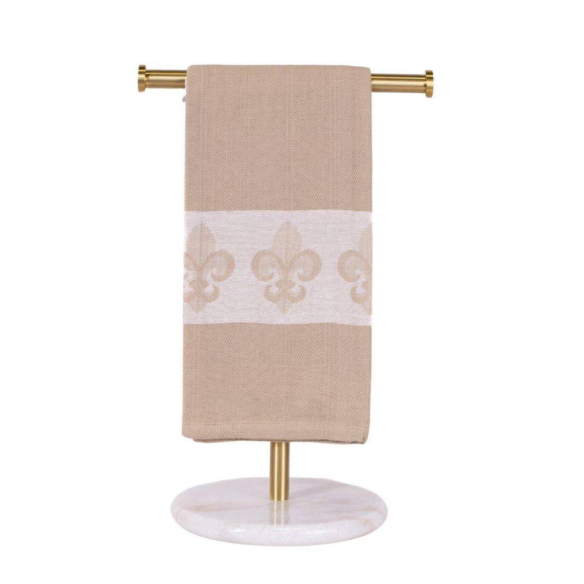 Beige towel with white lace design hanging on a gold towel rack with marble base.