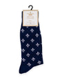 Navy blue sock with white fleur-de-lis pattern on a hanger with 'The Royal Standard' label.