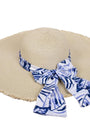 Beige straw hat with a blue and white patterned ribbon on a white background