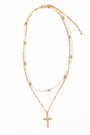 Gold necklace with a cross pendant on a white background