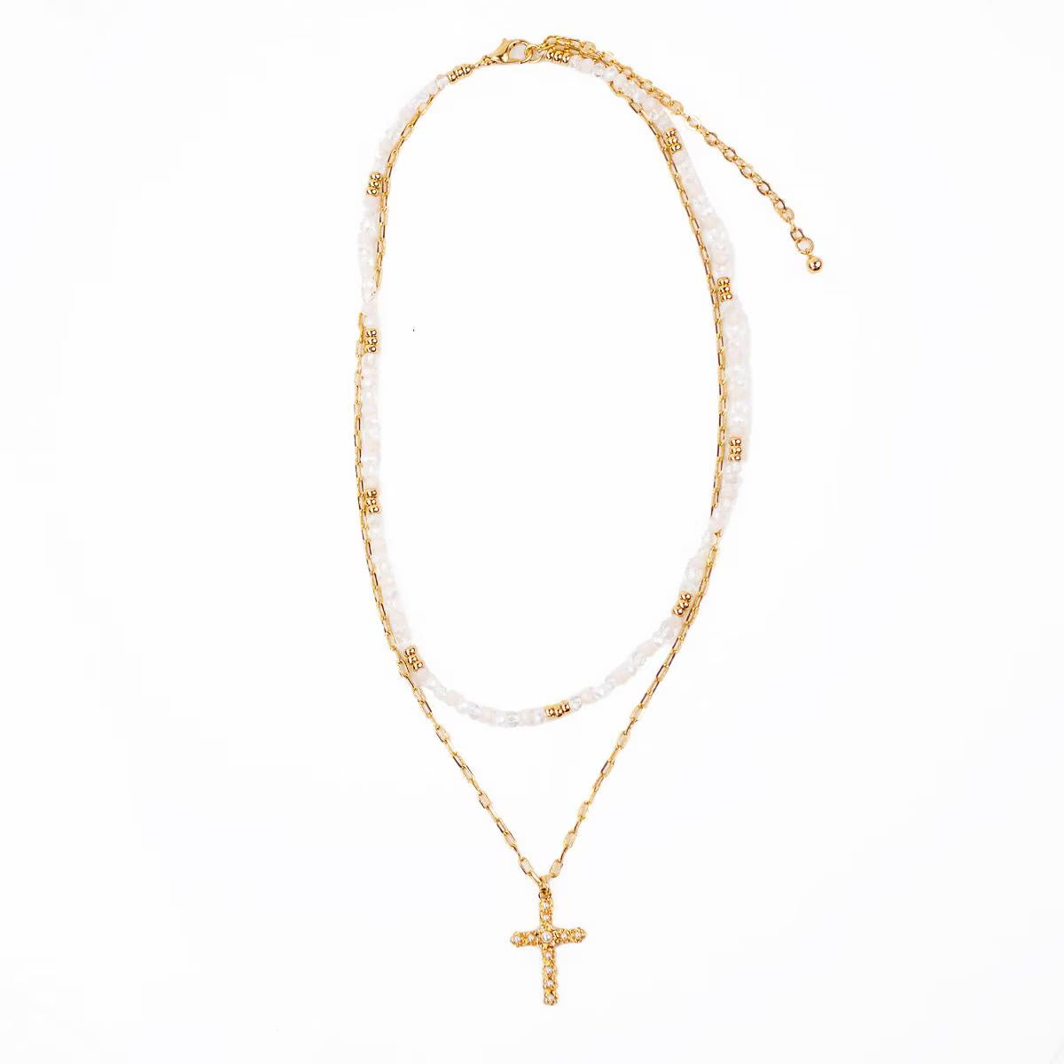 Gold necklace with a cross pendant on a white background