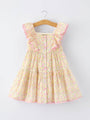 Floral dress on a hanger against a white background