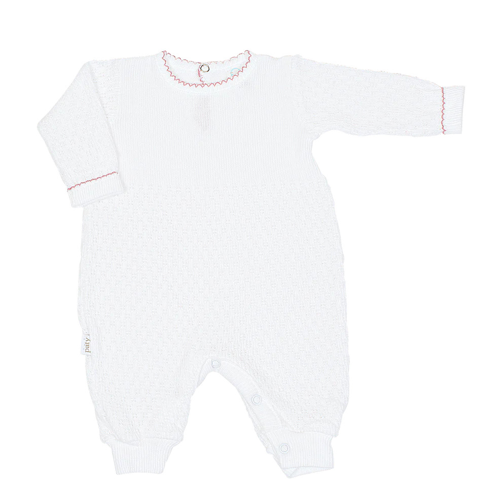 White baby romper with red trim on a white background