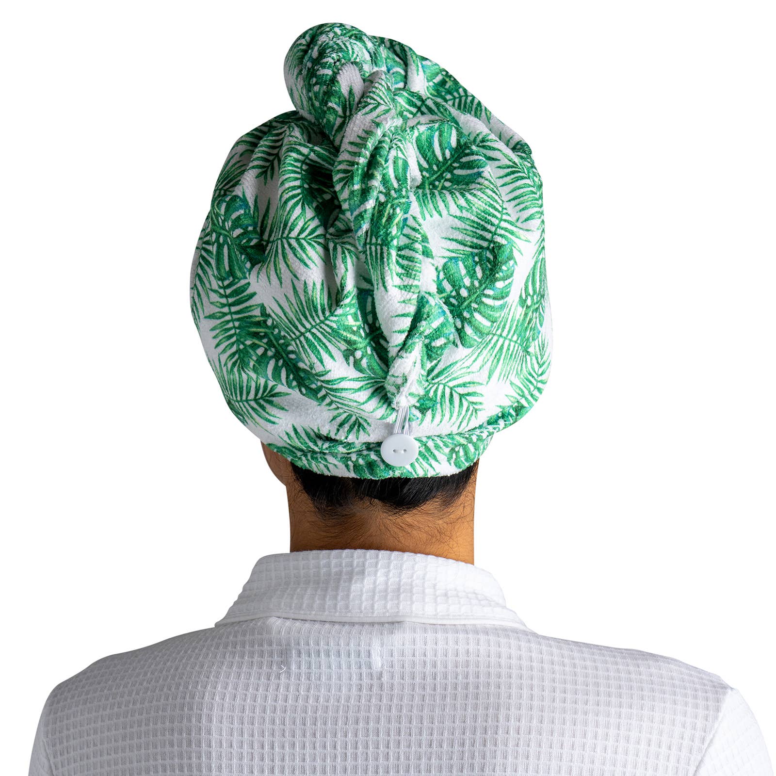 Green and white patterned towel on a person's head against a white background