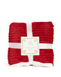 Red textured throw blanket with a white label on a white background
