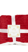 Red textured throw blanket with a white label on a white background